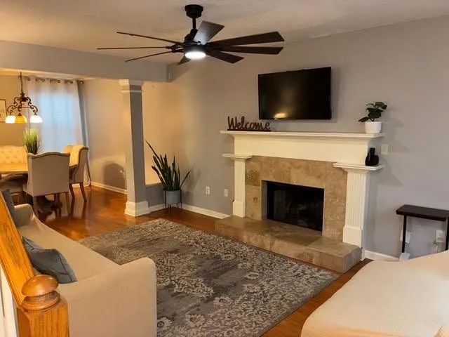 a living room with furniture and a fireplace