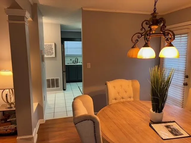 a dining room with furniture and wooden floor