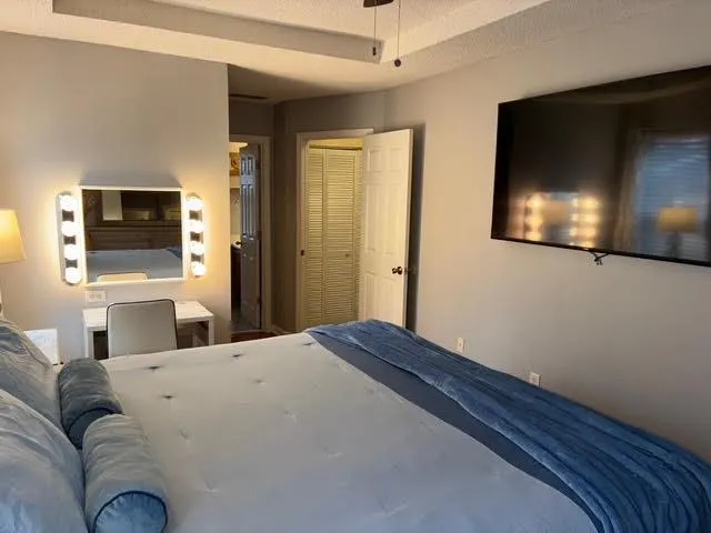 a bedroom with a bed and painting on the wall