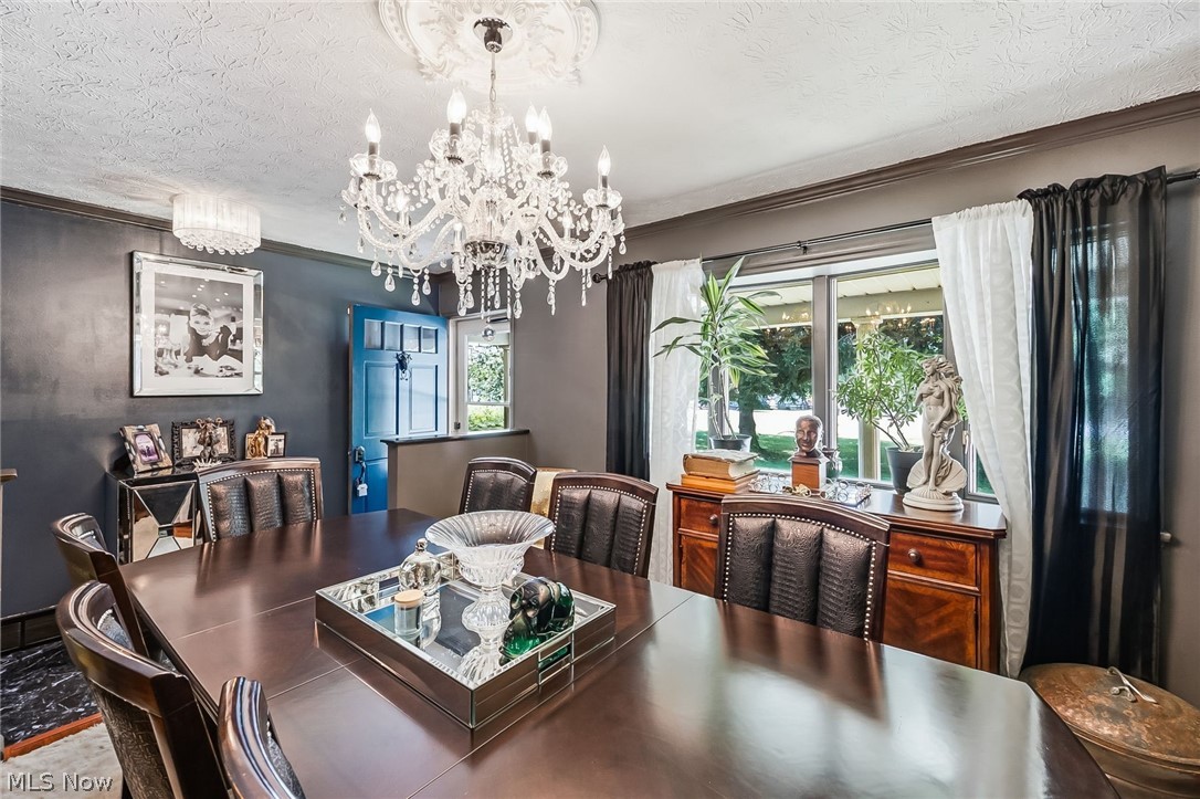 6890 Refugee Road Pickerington, OH 43147 - Photo 11 of 49 Formal dining space featuring a large chandelier with a decorative ceiling medallion