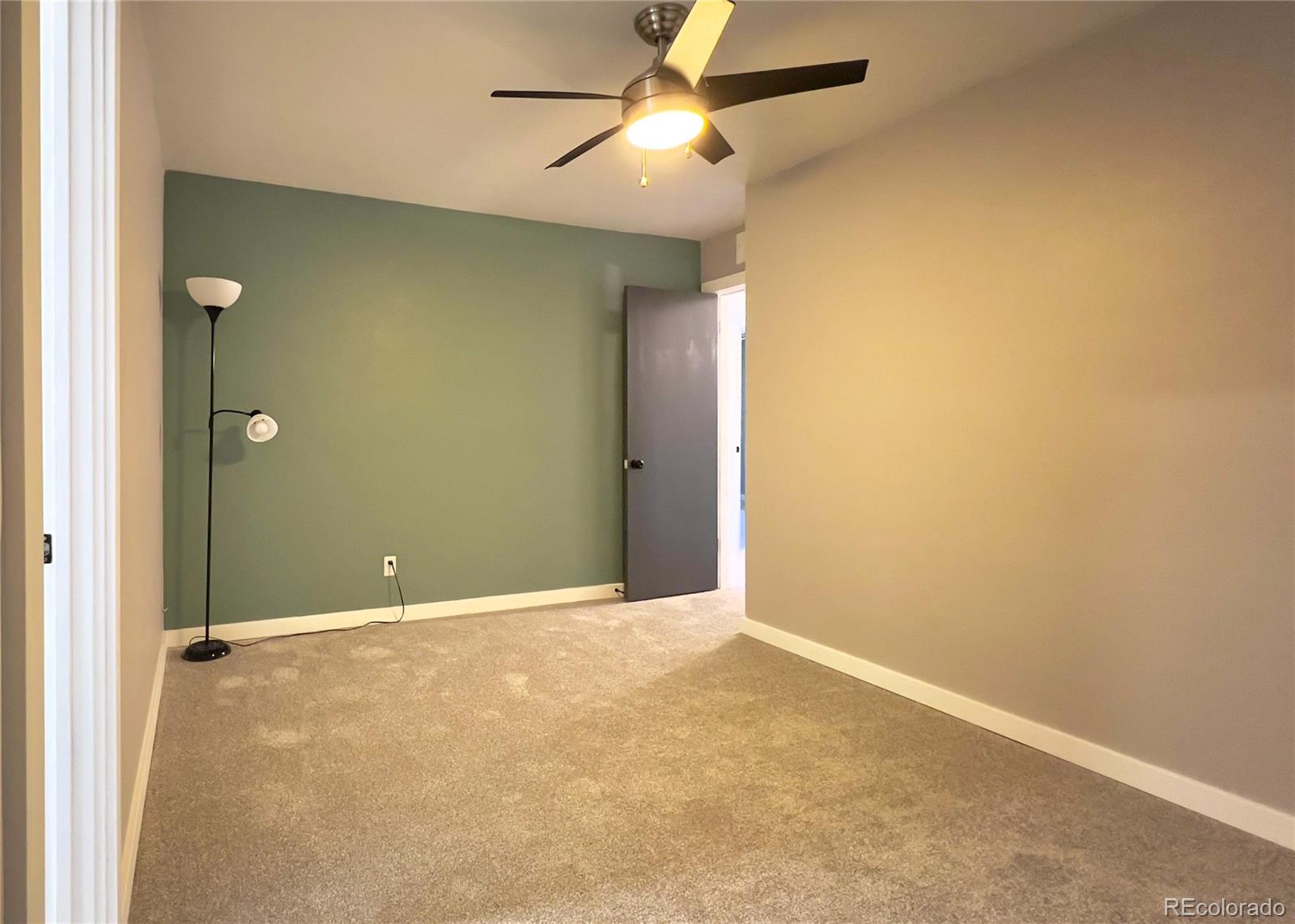 9190 High Street Thornton, CO 80229 - Photo 15 of 28 an empty room with closet and a chandelier fan