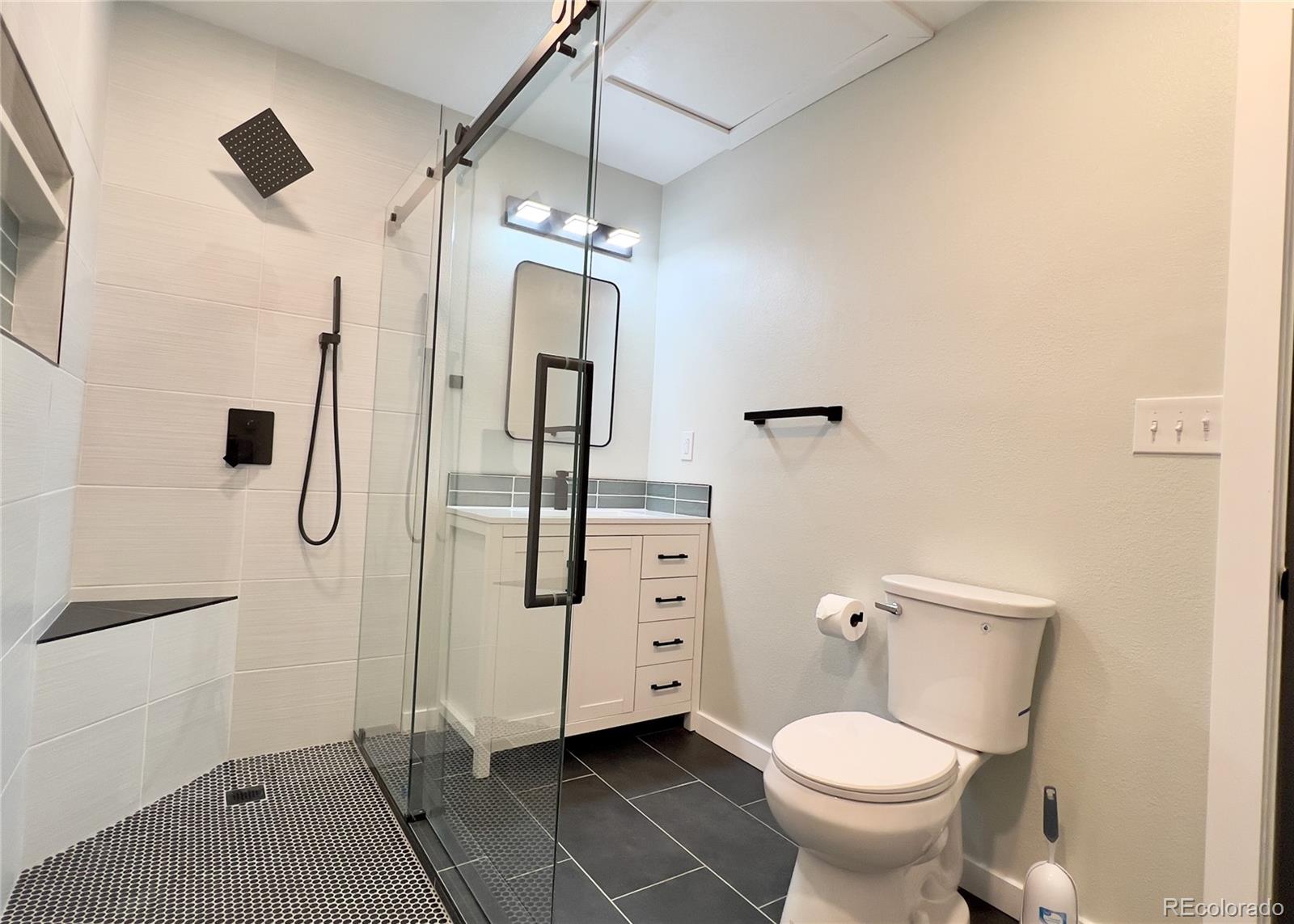 9190 High Street Thornton, CO 80229 - Photo 17 of 28 a bathroom with a granite countertop sink toilet and shower