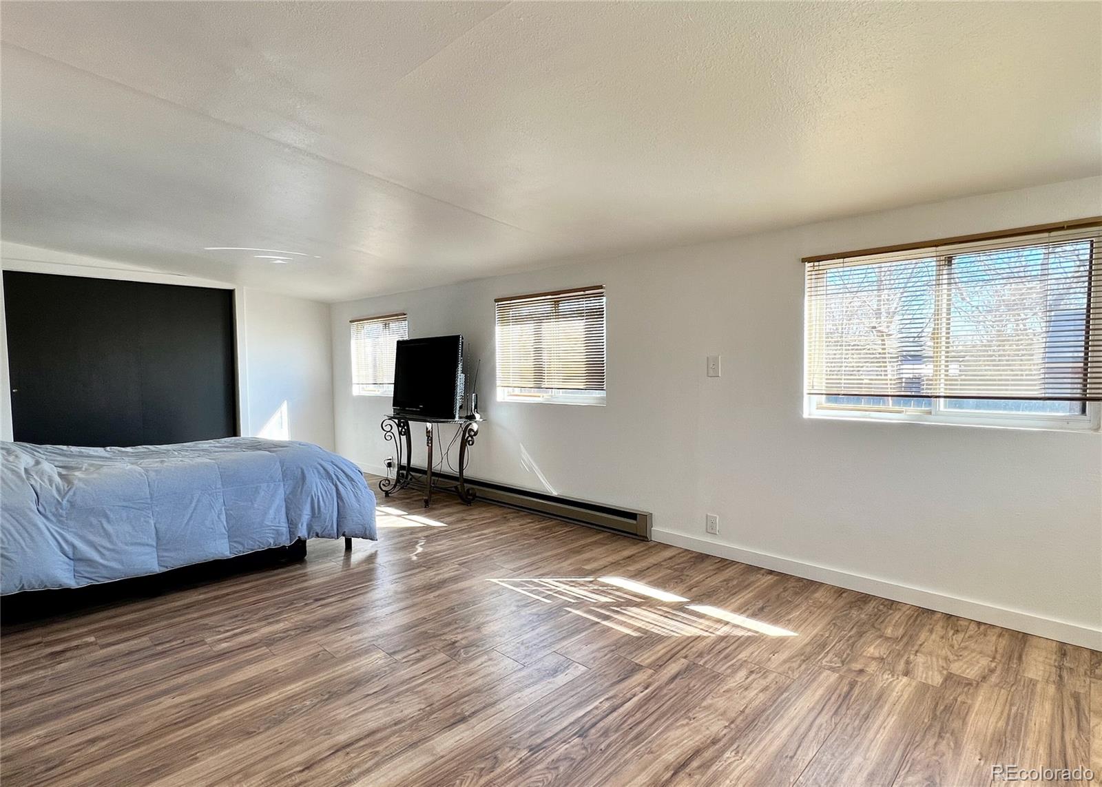 9190 High Street Thornton, CO 80229 - Photo 20 of 28 a bedroom with a bed and a flat screen tv