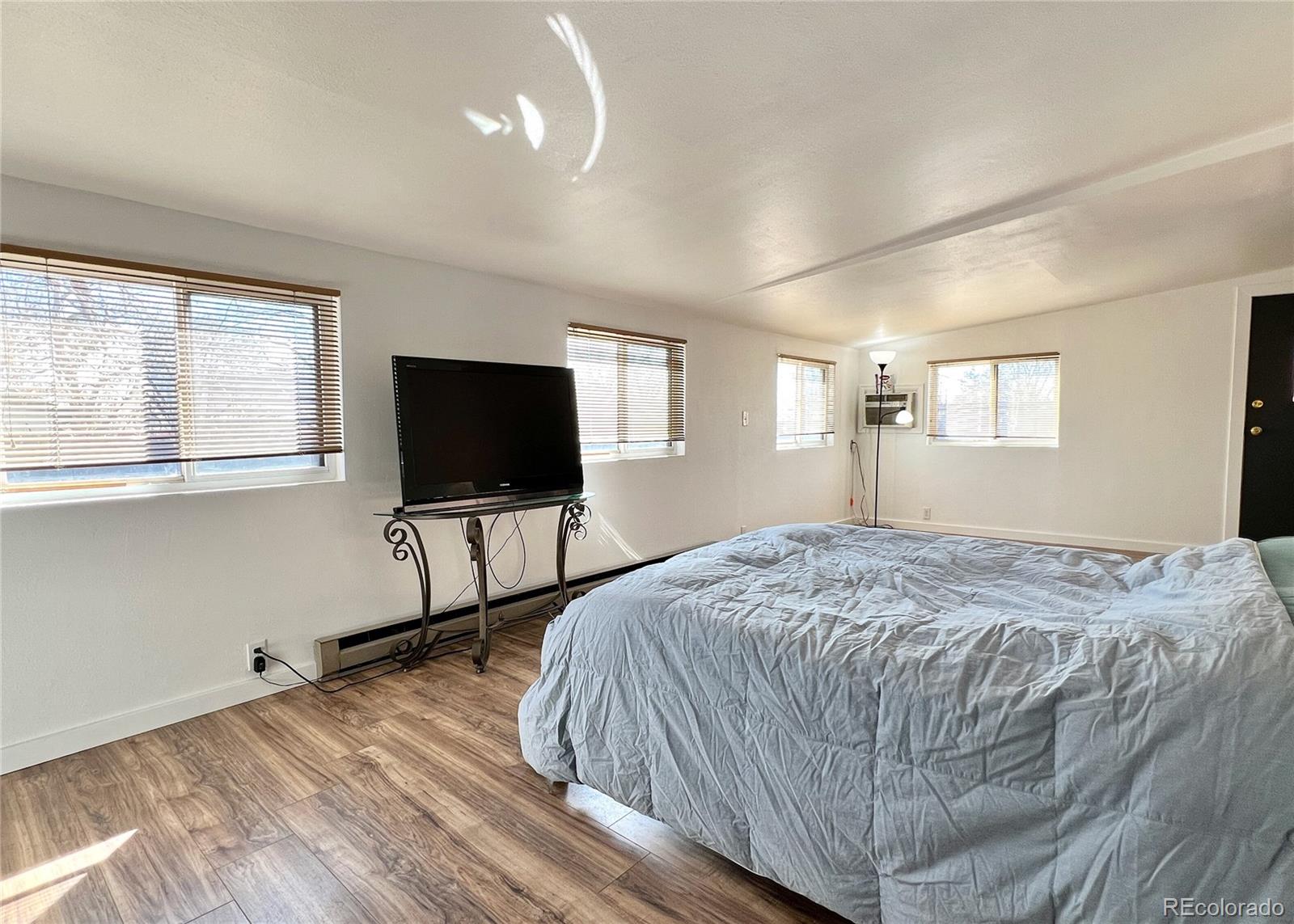 9190 High Street Thornton, CO 80229 - Photo 21 of 28 a bedroom with a bed and a flat screen tv