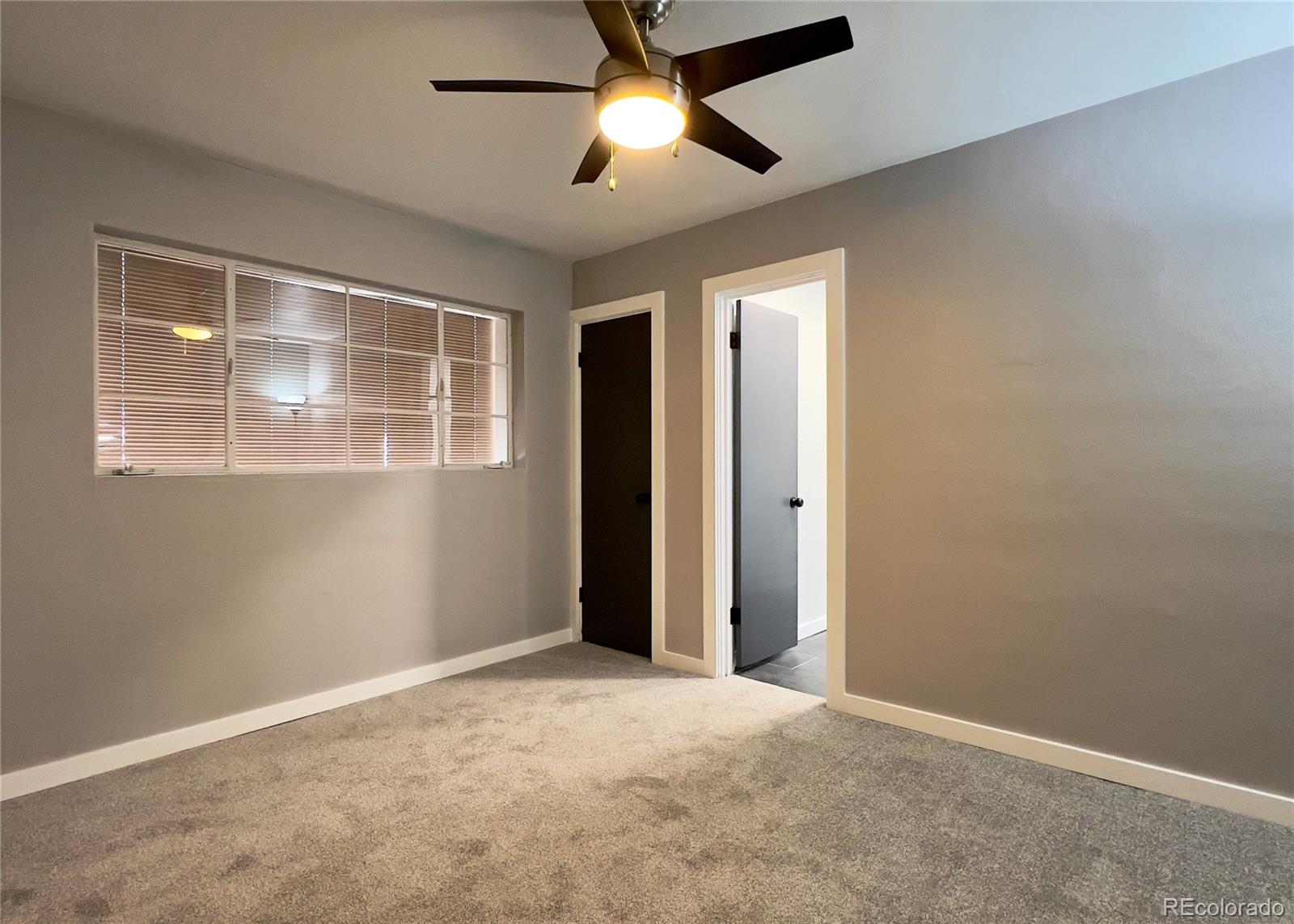 9190 High Street Thornton, CO 80229 - Photo 22 of 28 an empty room with chandelier fan and windows