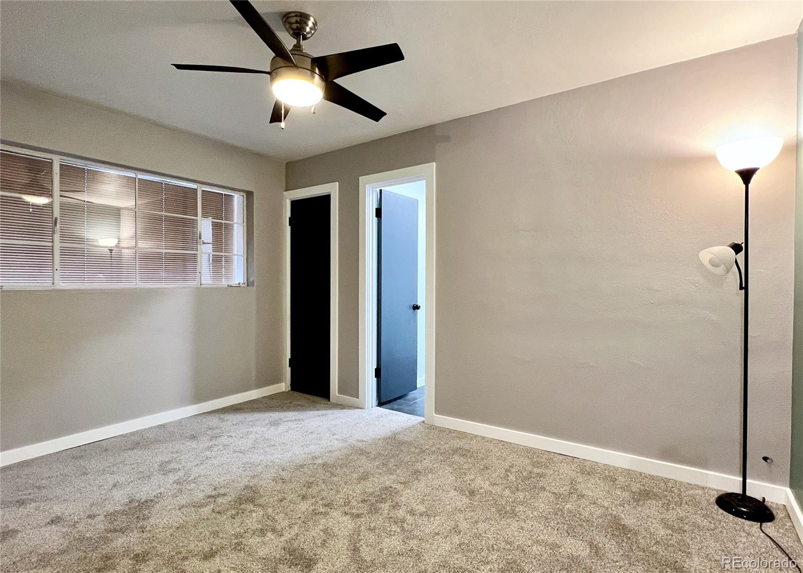 9190 High Street Thornton, CO 80229 - Photo 23 of 28 a view of an empty room with a chandelier fan