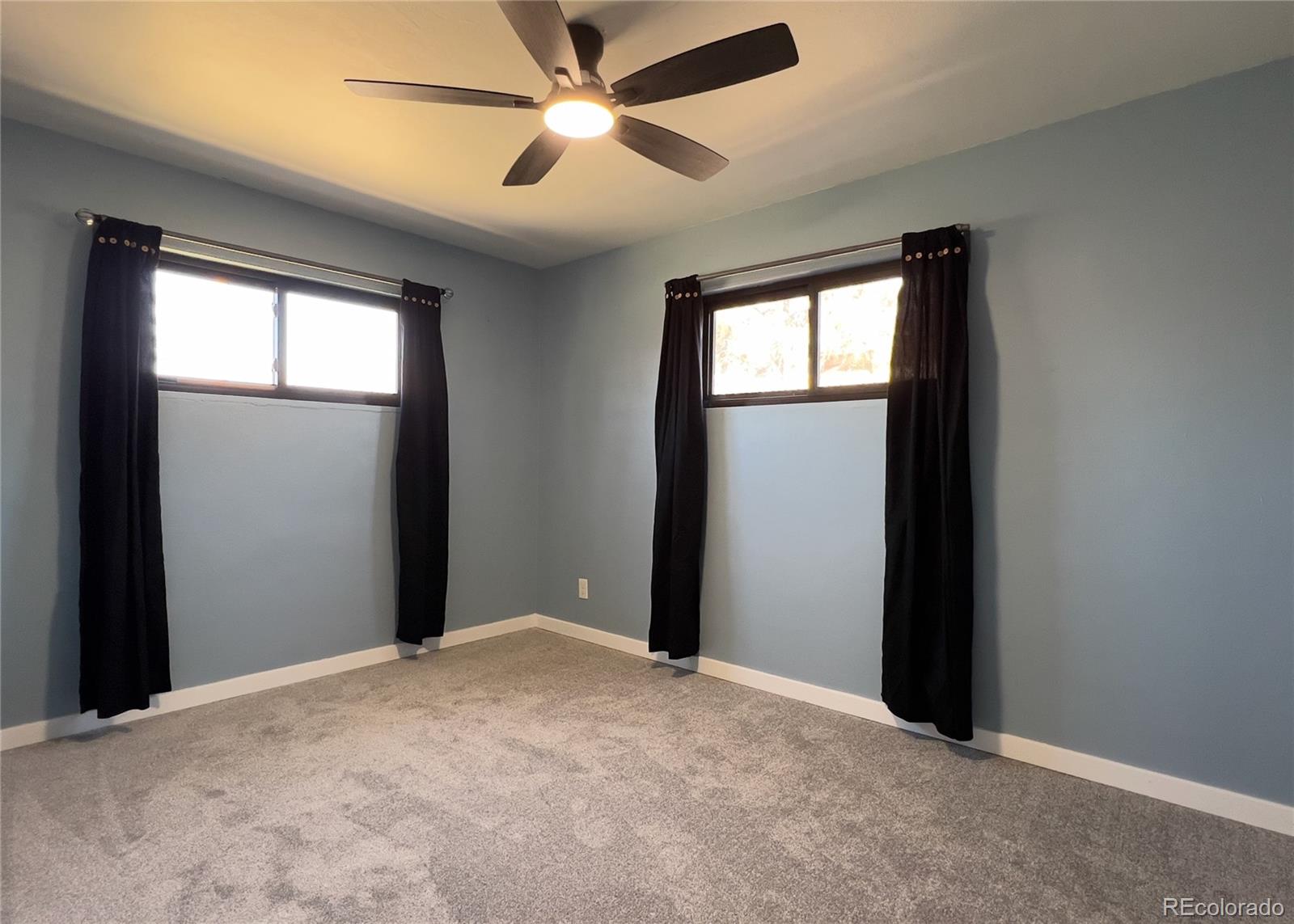 9190 High Street Thornton, CO 80229 - Photo 25 of 28 a view of a big room with closet and a ceiling fan