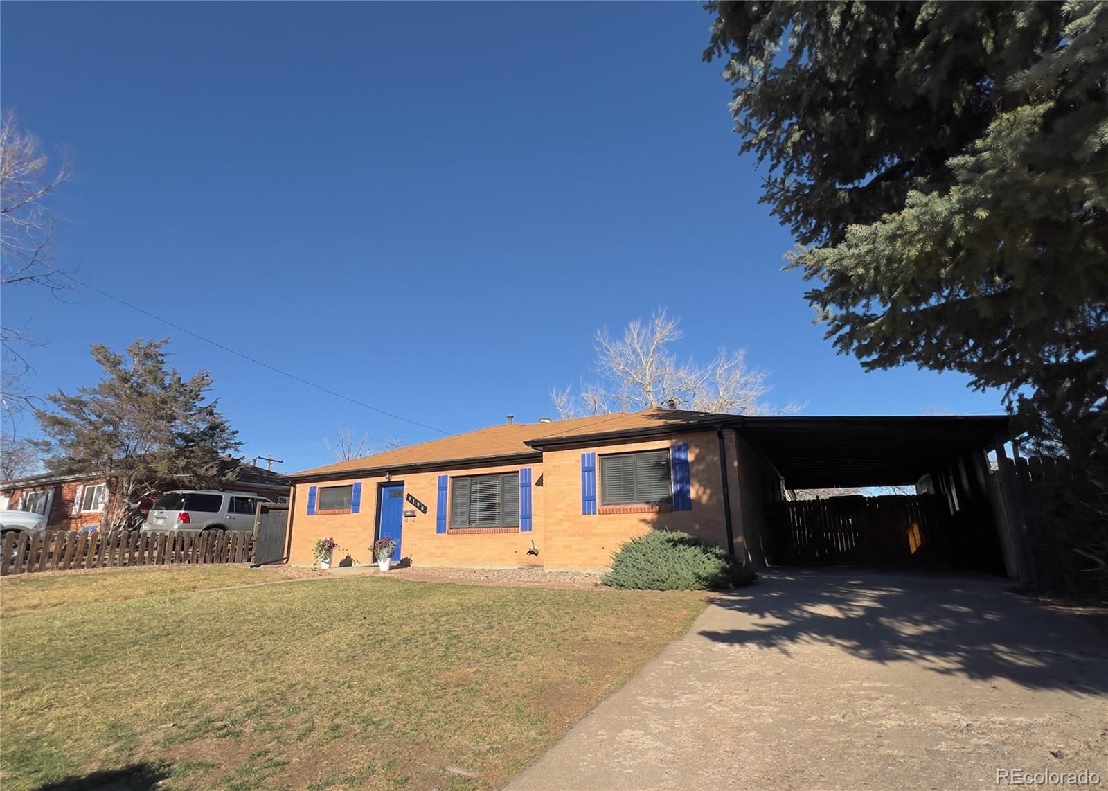 9190 High Street Thornton, CO 80229 - Photo 4 of 28 a front view of a house with a yard and garage