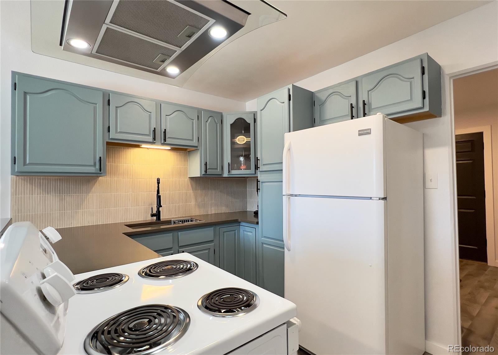 9190 High Street Thornton, CO 80229 - Photo 9 of 28 a kitchen with a refrigerator a stove a sink and a refrigerator