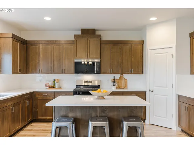 a kitchen with a sink cabinets and wooden floor
