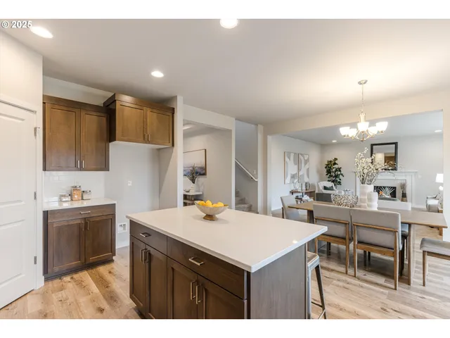 a kitchen with kitchen island a sink stove and refrigerator
