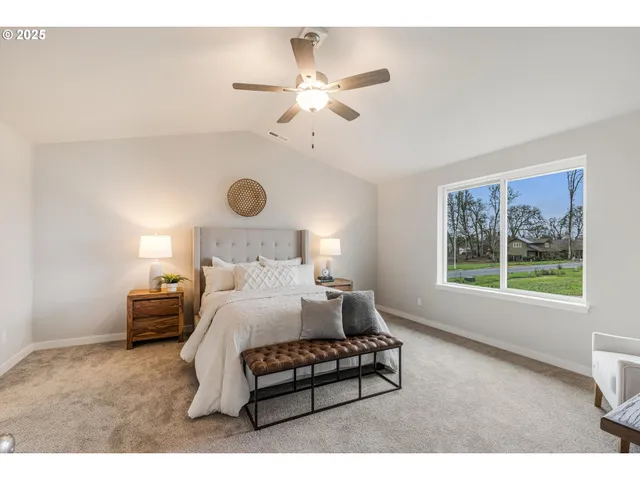 a bedroom with a bed mirror and window