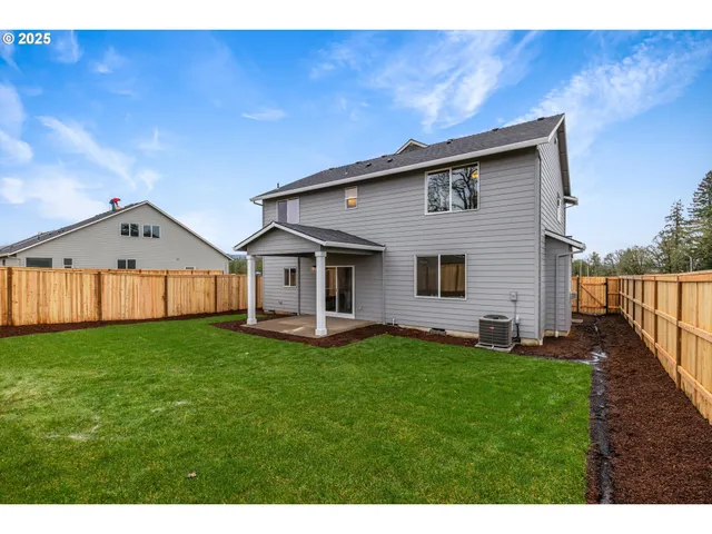 a front view of a house with a yard and deck