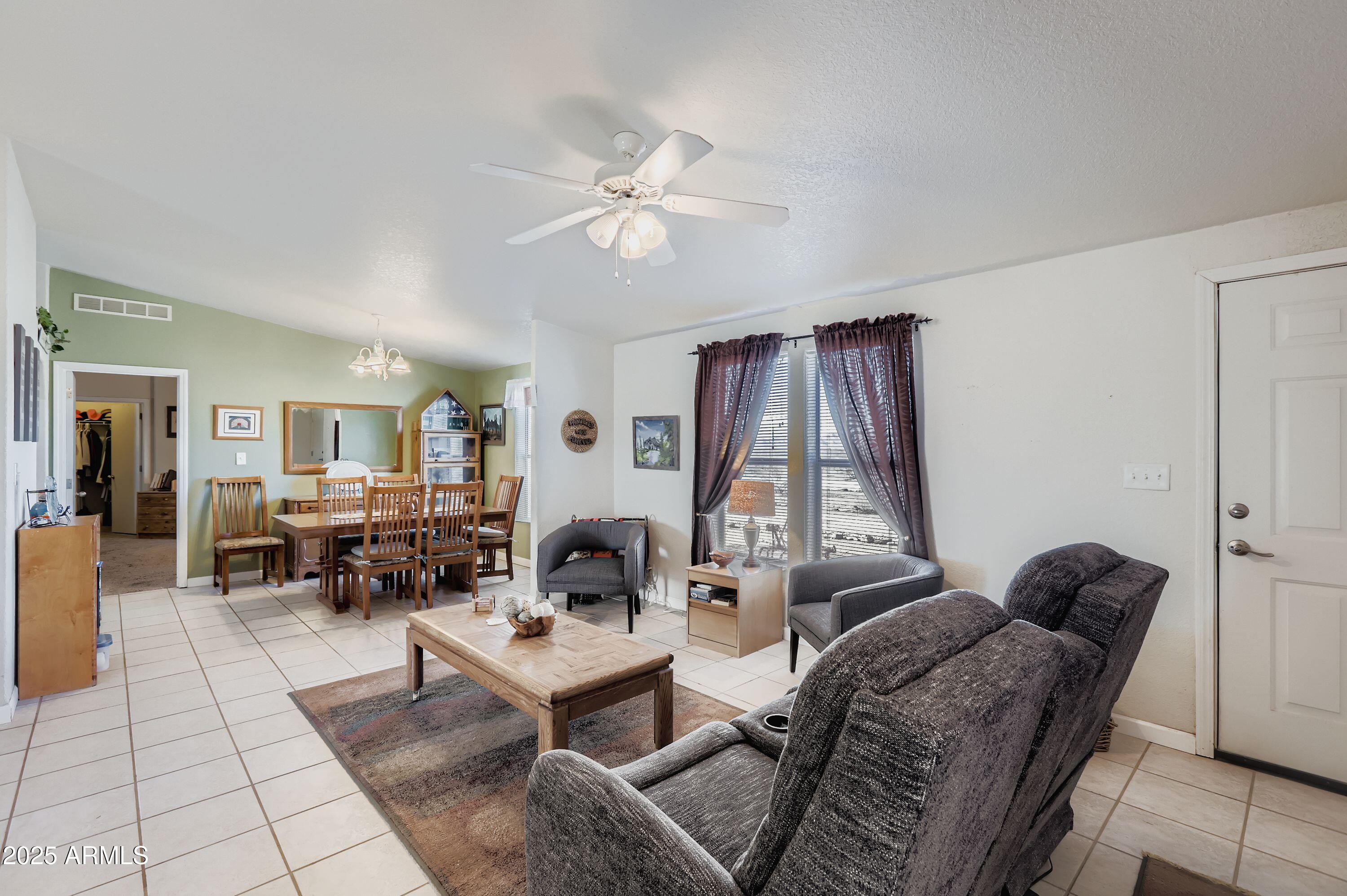 20607 West Chandler Heights Road Buckeye, AZ 85326 - Photo 11 of 29 a living room with furniture and wooden floor