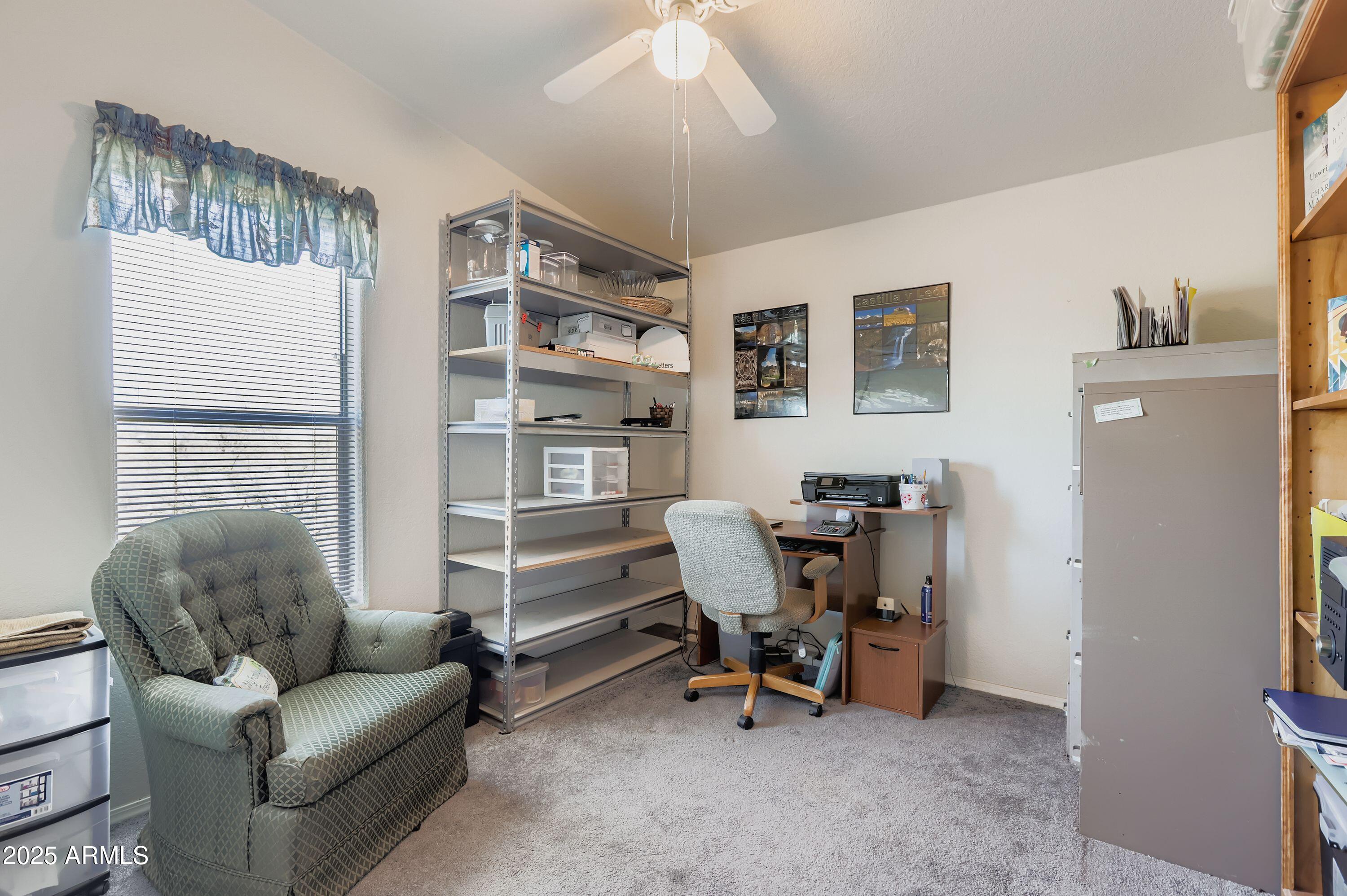 20607 West Chandler Heights Road Buckeye, AZ 85326 - Photo 14 of 29 a view of a livingroom with workspace and a couch