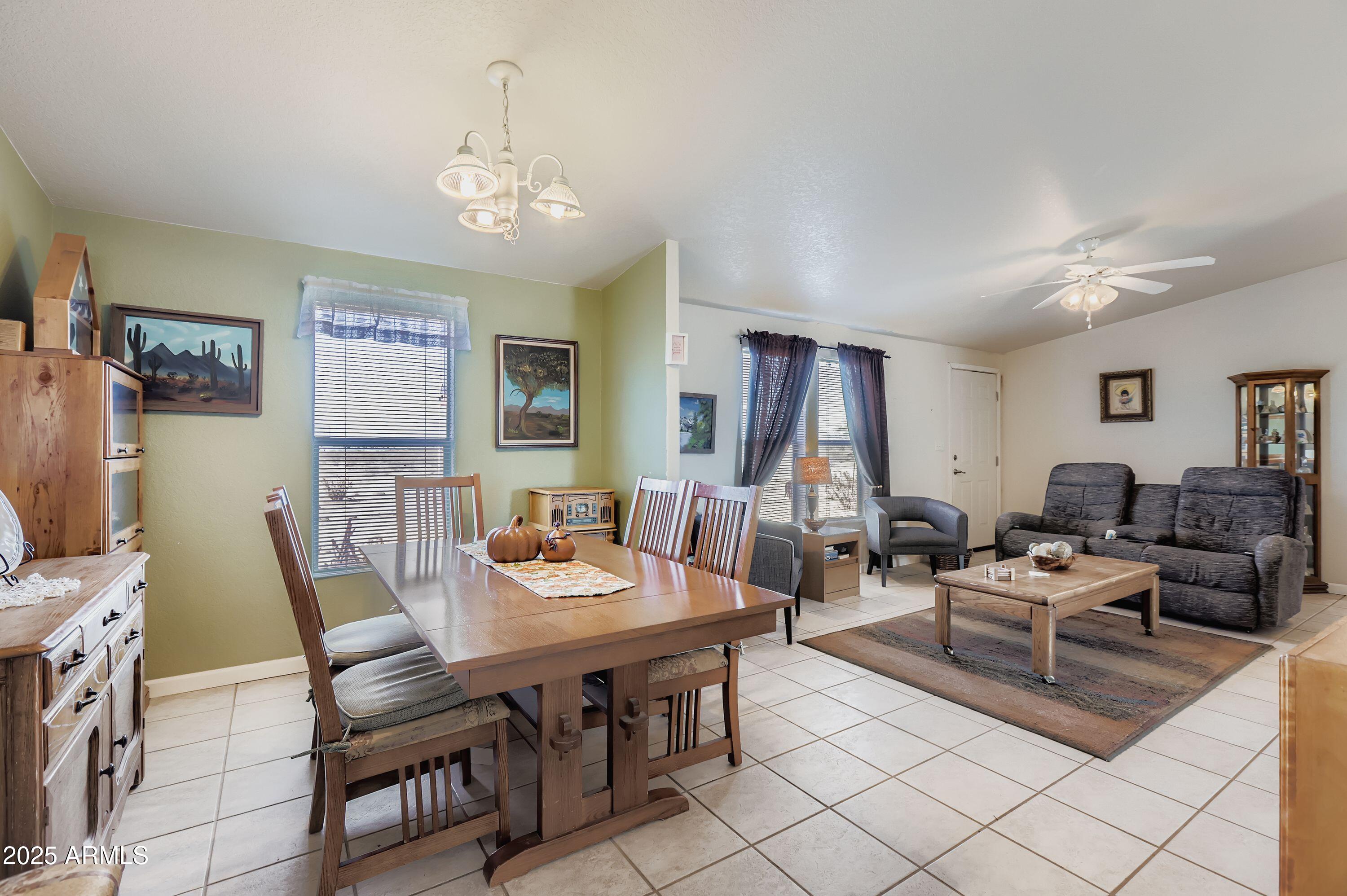 20607 West Chandler Heights Road Buckeye, AZ 85326 - Photo 15 of 29 a living room with furniture and a chandelier