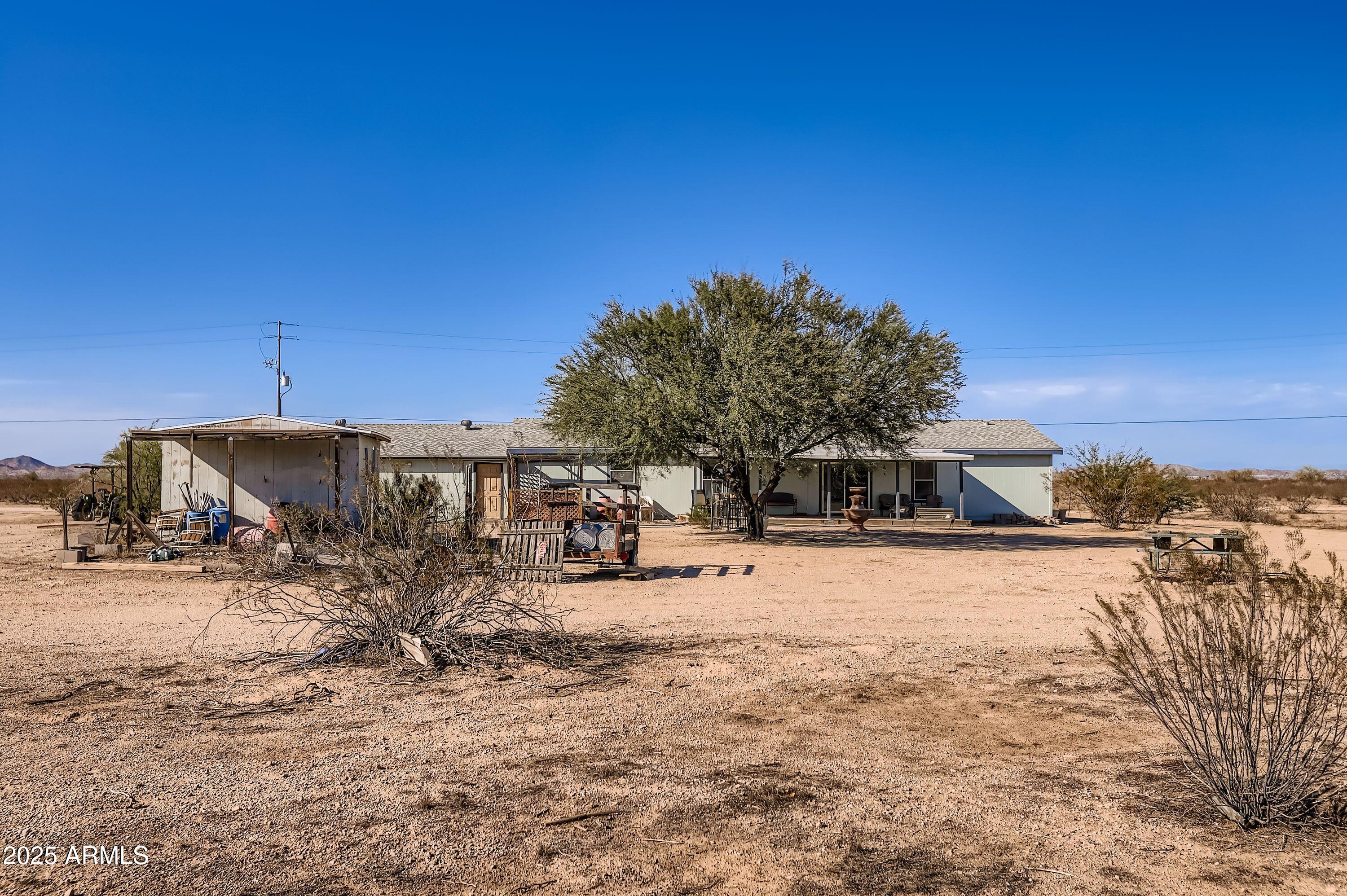 20607 West Chandler Heights Road Buckeye, AZ 85326 - Photo 16 of 29 a view of a dirt road with a building in the background