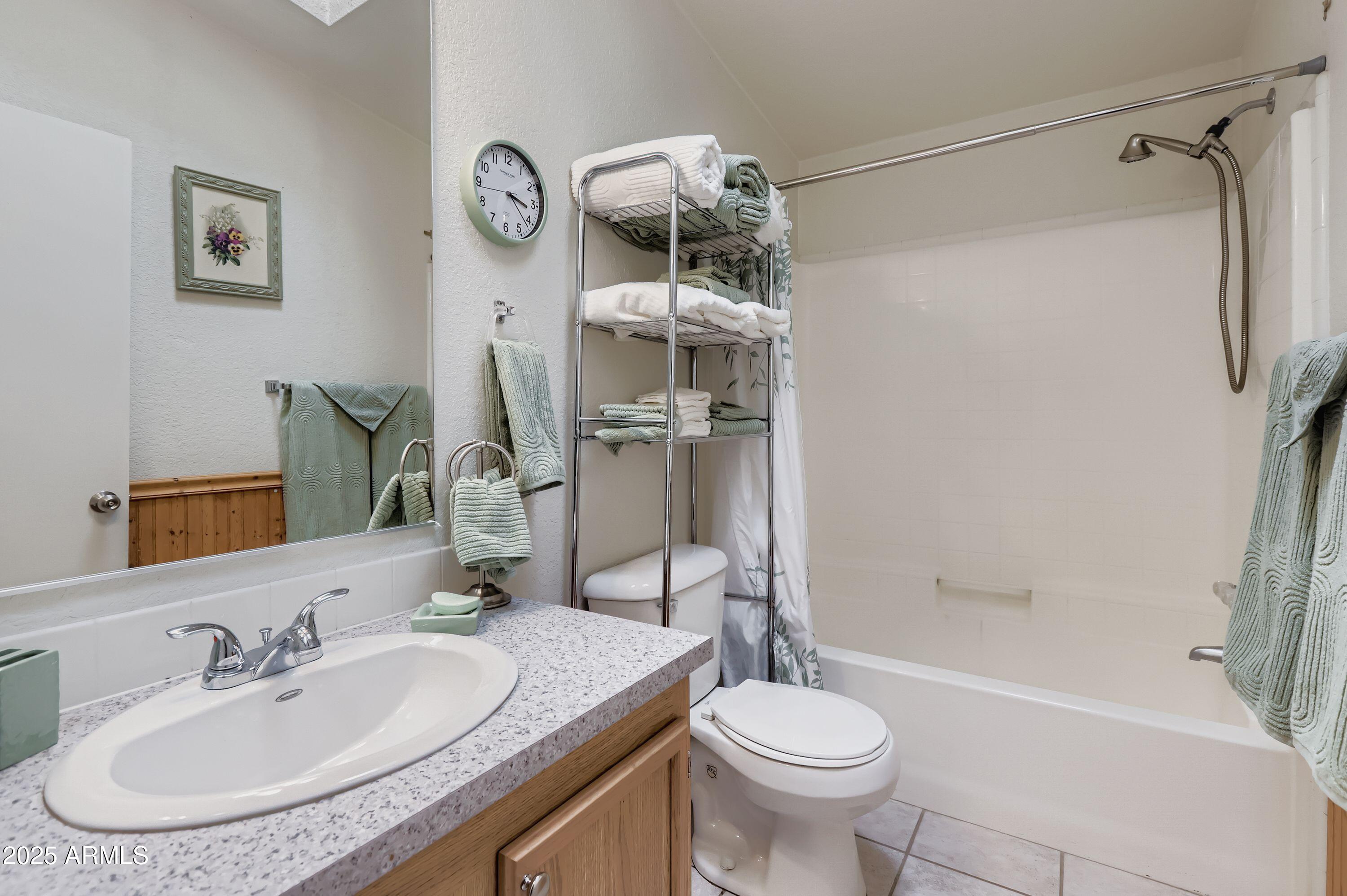 20607 West Chandler Heights Road Buckeye, AZ 85326 - Photo 17 of 29 a bathroom with a granite countertop sink toilet and shower