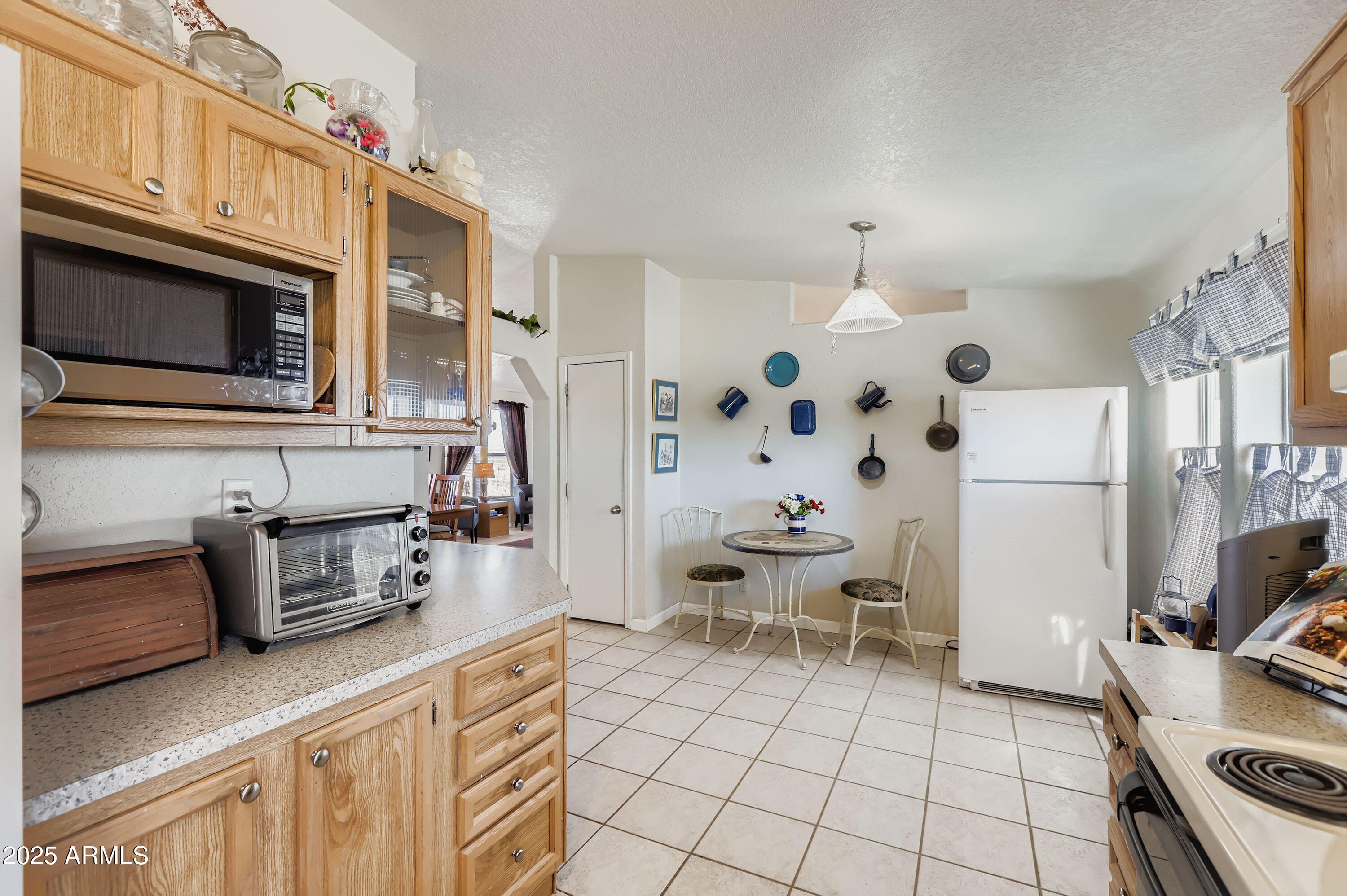 20607 West Chandler Heights Road Buckeye, AZ 85326 - Photo 18 of 29 a kitchen with stainless steel appliances a stove a sink and a microwave