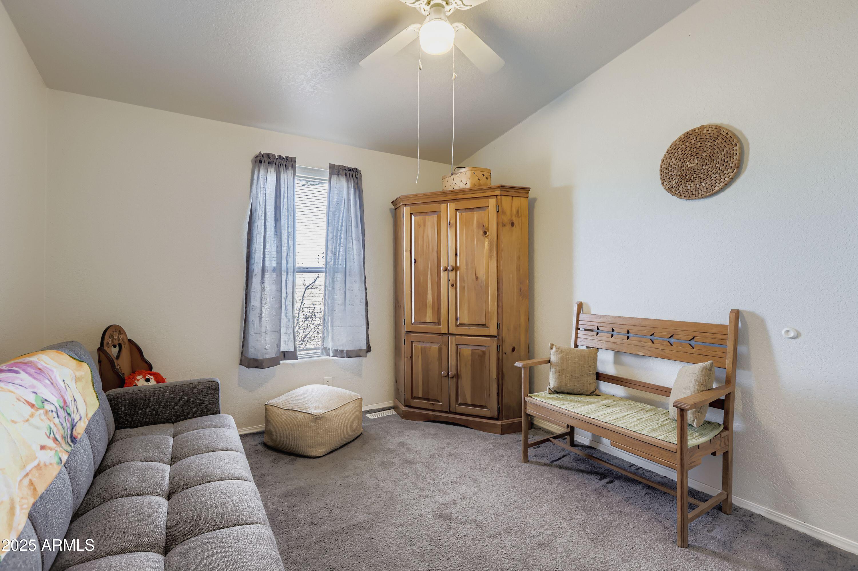 20607 West Chandler Heights Road Buckeye, AZ 85326 - Photo 19 of 29 a living room with furniture and a chandelier