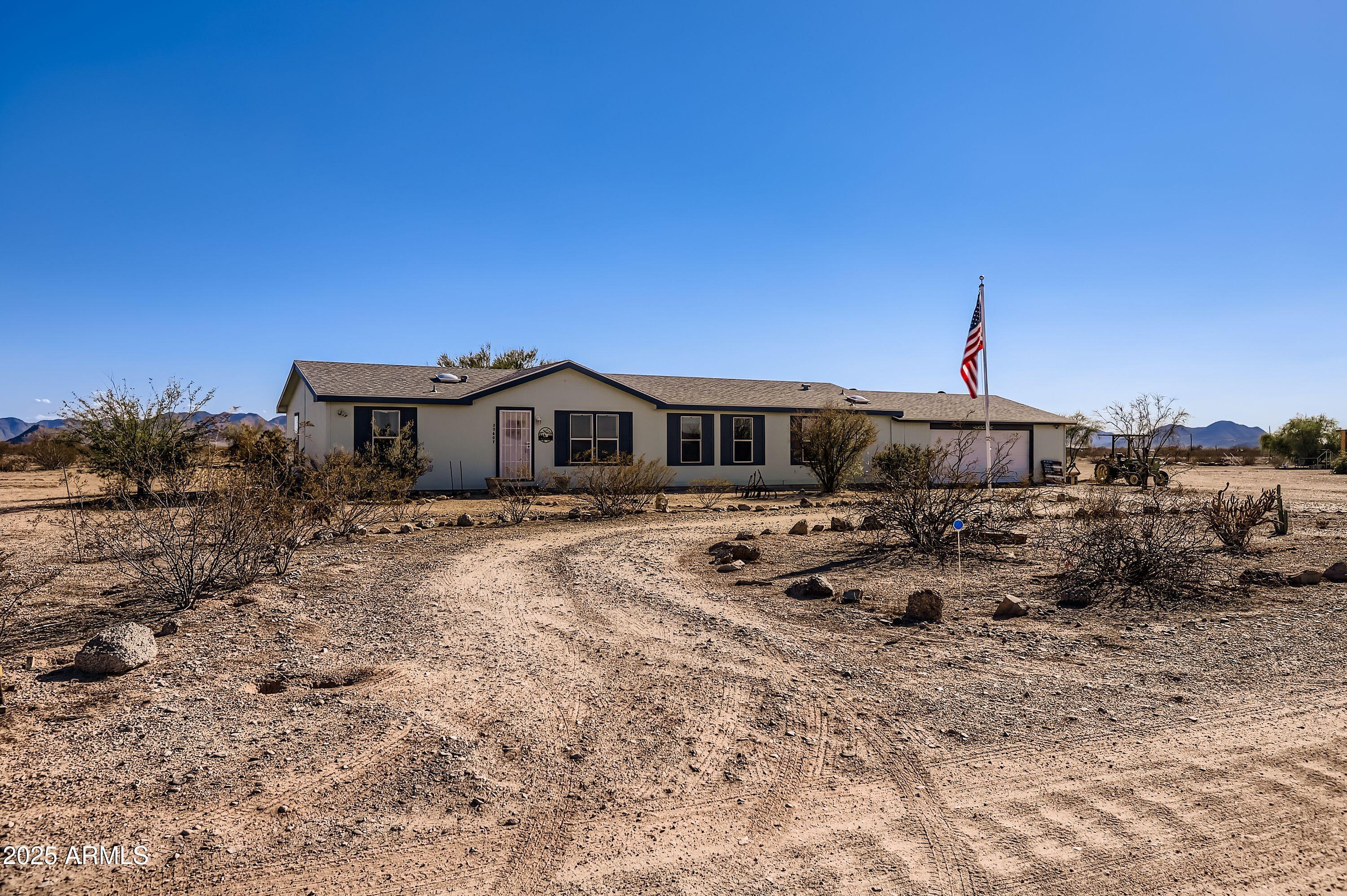 20607 West Chandler Heights Road Buckeye, AZ 85326 - Photo 20 of 29 a front view of a house with a yard
