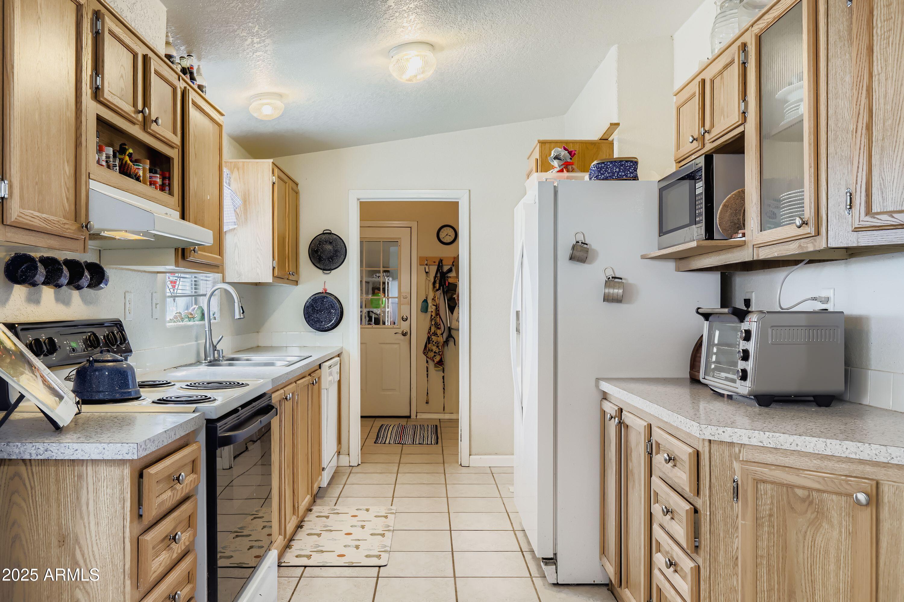 20607 West Chandler Heights Road Buckeye, AZ 85326 - Photo 9 of 29 a kitchen with stainless steel appliances granite countertop a stove and a cabinets