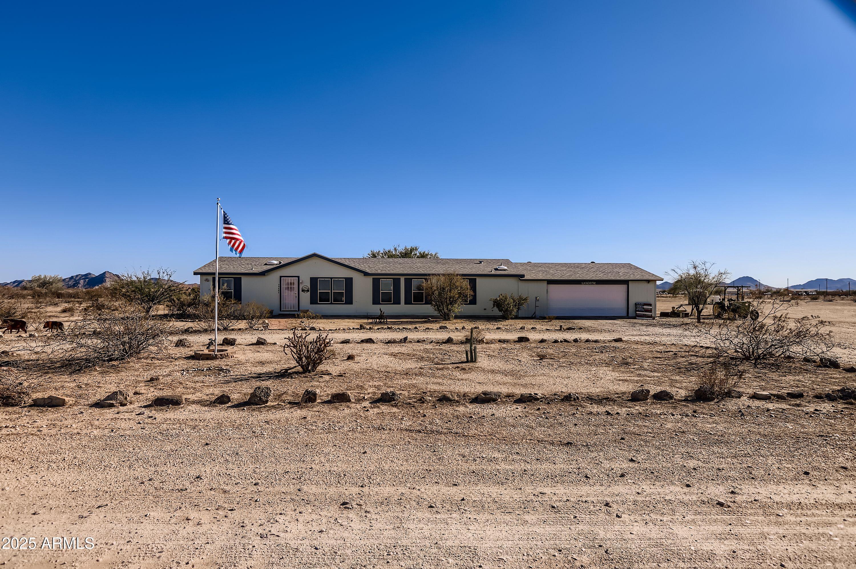 20607 West Chandler Heights Road Buckeye, AZ 85326 - Photo 10 of 29 a front view of a house with a yard