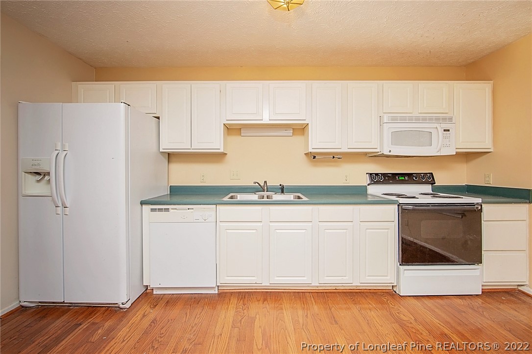 138 Pecan Trace Road Raeford, NC 28376 - Photo 16 of 42 a kitchen with granite countertop a refrigerator and a stove top oven