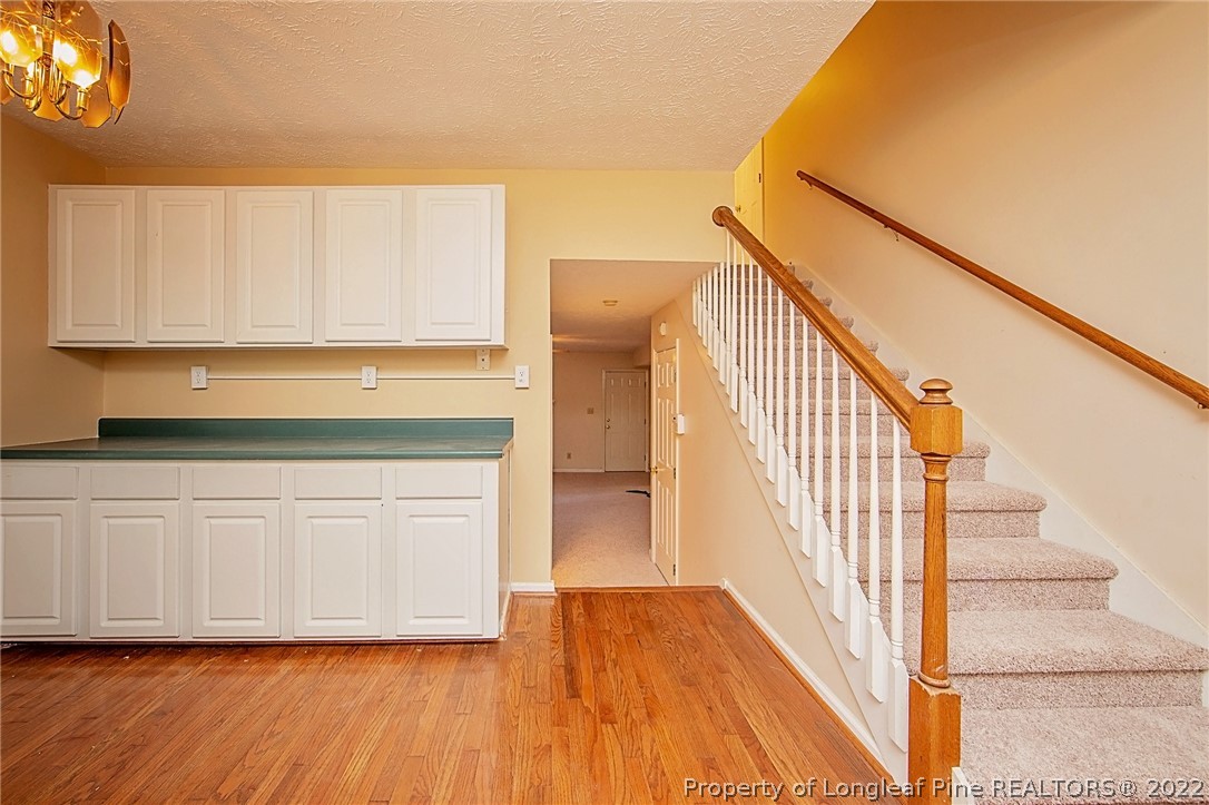 138 Pecan Trace Road Raeford, NC 28376 - Photo 17 of 42 a view of a hallway with wooden floor and staircase
