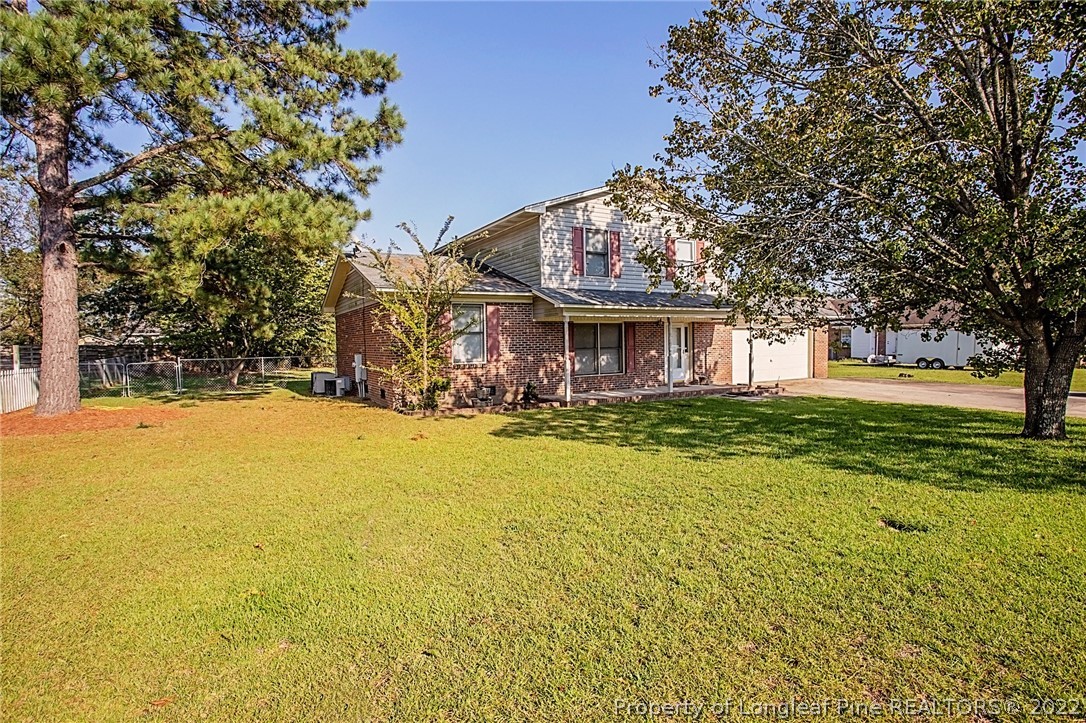 138 Pecan Trace Road Raeford, NC 28376 - Photo 2 of 42 a view of a house with a yard