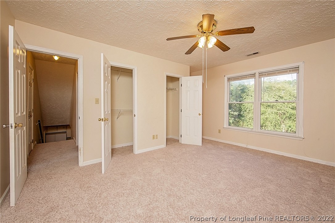 138 Pecan Trace Road Raeford, NC 28376 - Photo 34 of 42 an empty room with chandelier fan and windows