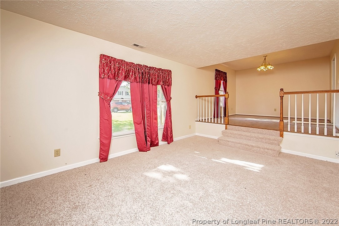 138 Pecan Trace Road Raeford, NC 28376 - Photo 8 of 42 a view of a room with wooden walls and a window