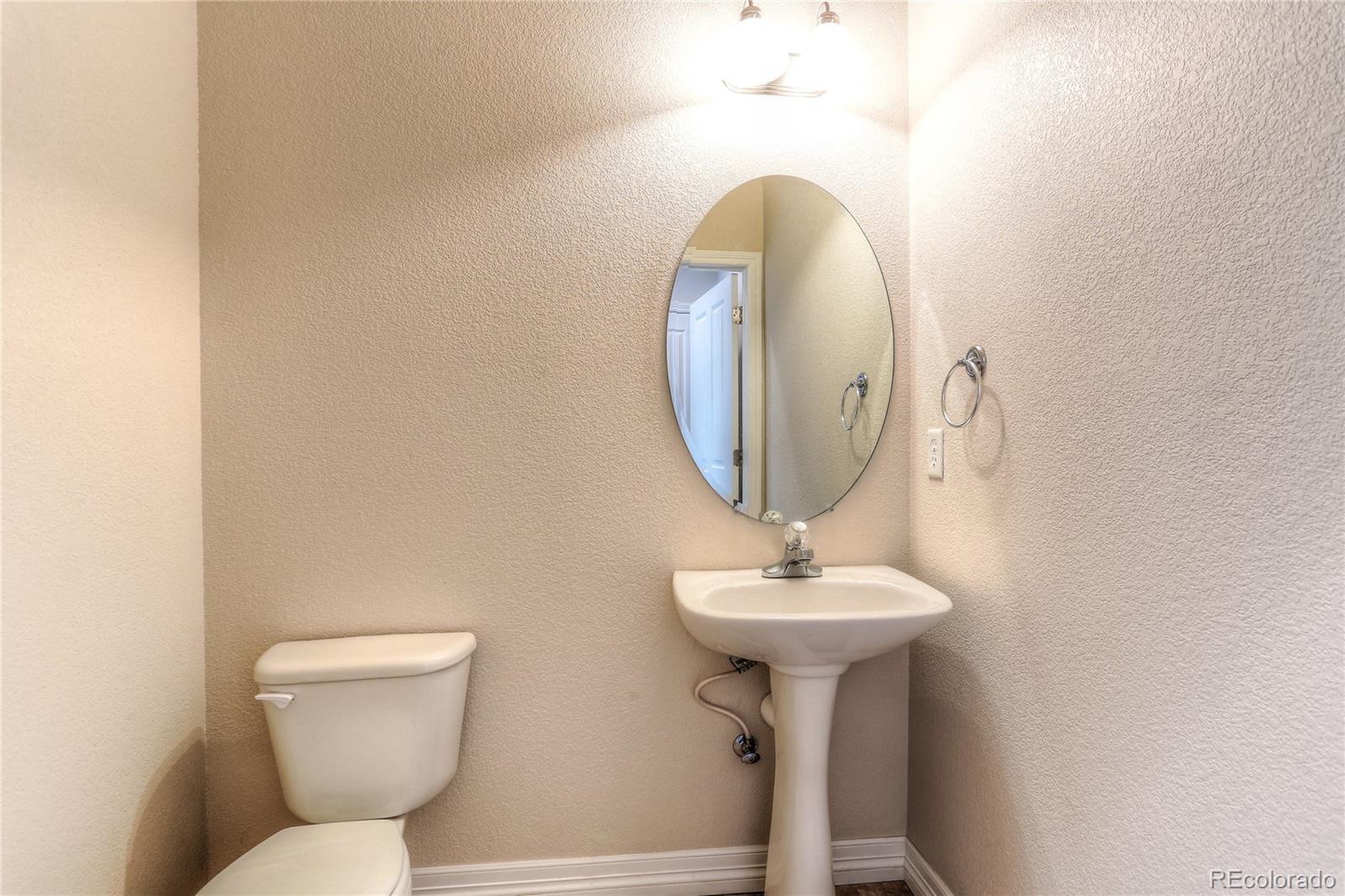 10178 RidgeGate Circle Lone Tree, CO 80124 - Photo 12 of 22 a bathroom with a toilet sink and mirror