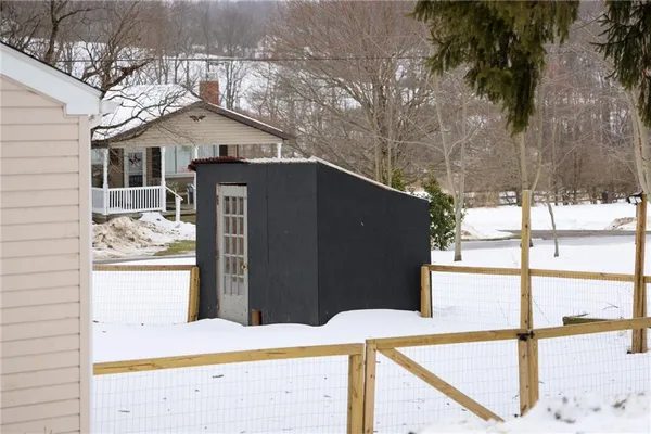 a view of a house with snow in the background