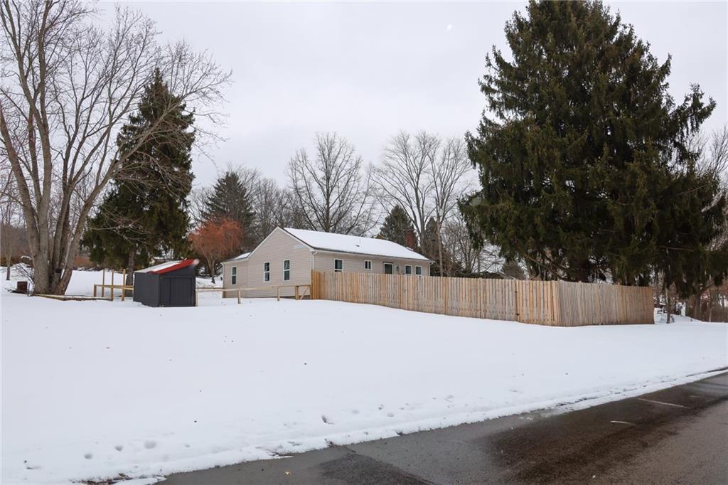 125 Church Road Slippery Rock, PA 16057 - Photo 33 of 38 A street view from Church Rd of the enclosed front yard with a privacy fence and the chicken coop on the side yard.