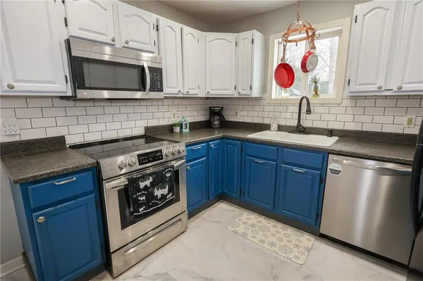 a kitchen with a sink stove and microwave