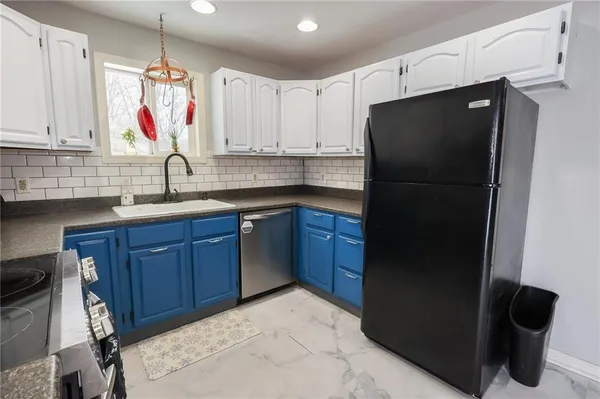 a kitchen with a sink and a refrigerator
