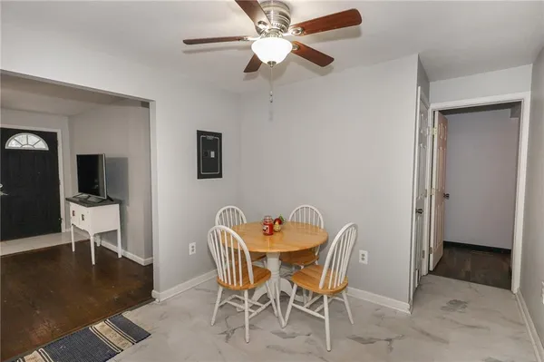 a dining room with furniture and wooden floor