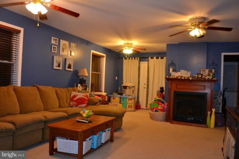 559 Union Church Road Elkton, MD 21921 - Photo 7 of 30 Family Room with gas stove and sliders to deck