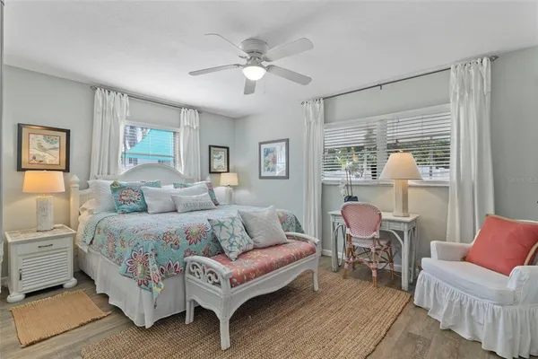 a spacious bedroom with a bed and a chandelier