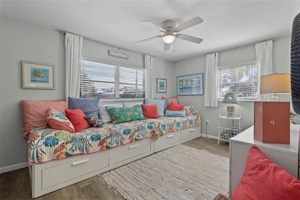 a bedroom with a bed and a chandelier