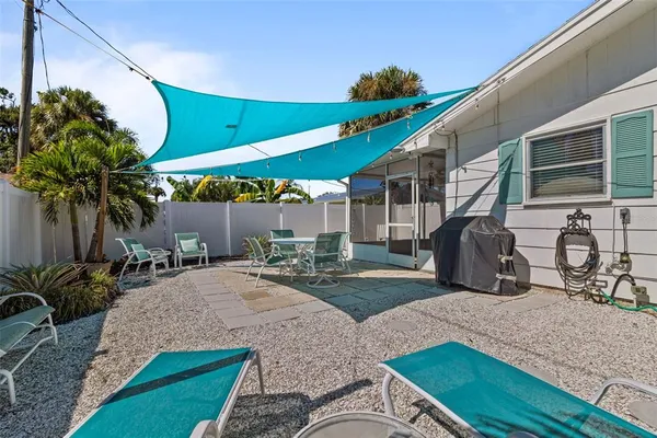 a view of a house with backyard and sitting area