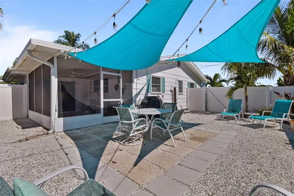 a view of a patio with a table and chairs under an umbrella