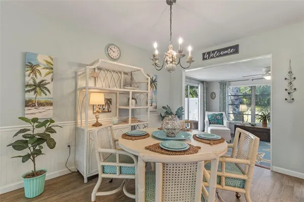 a view of a dining room with furniture wooden floor and chandelier