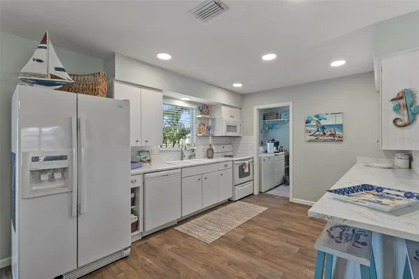a kitchen with stainless steel appliances a refrigerator and a stove top oven