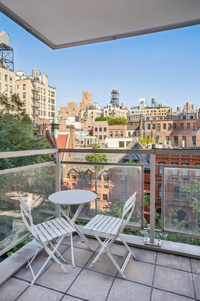 150 East 69th Street, Unit 5J Manhattan, NY 10021 - Photo 10 of 11 a view of a balcony with chair and tables