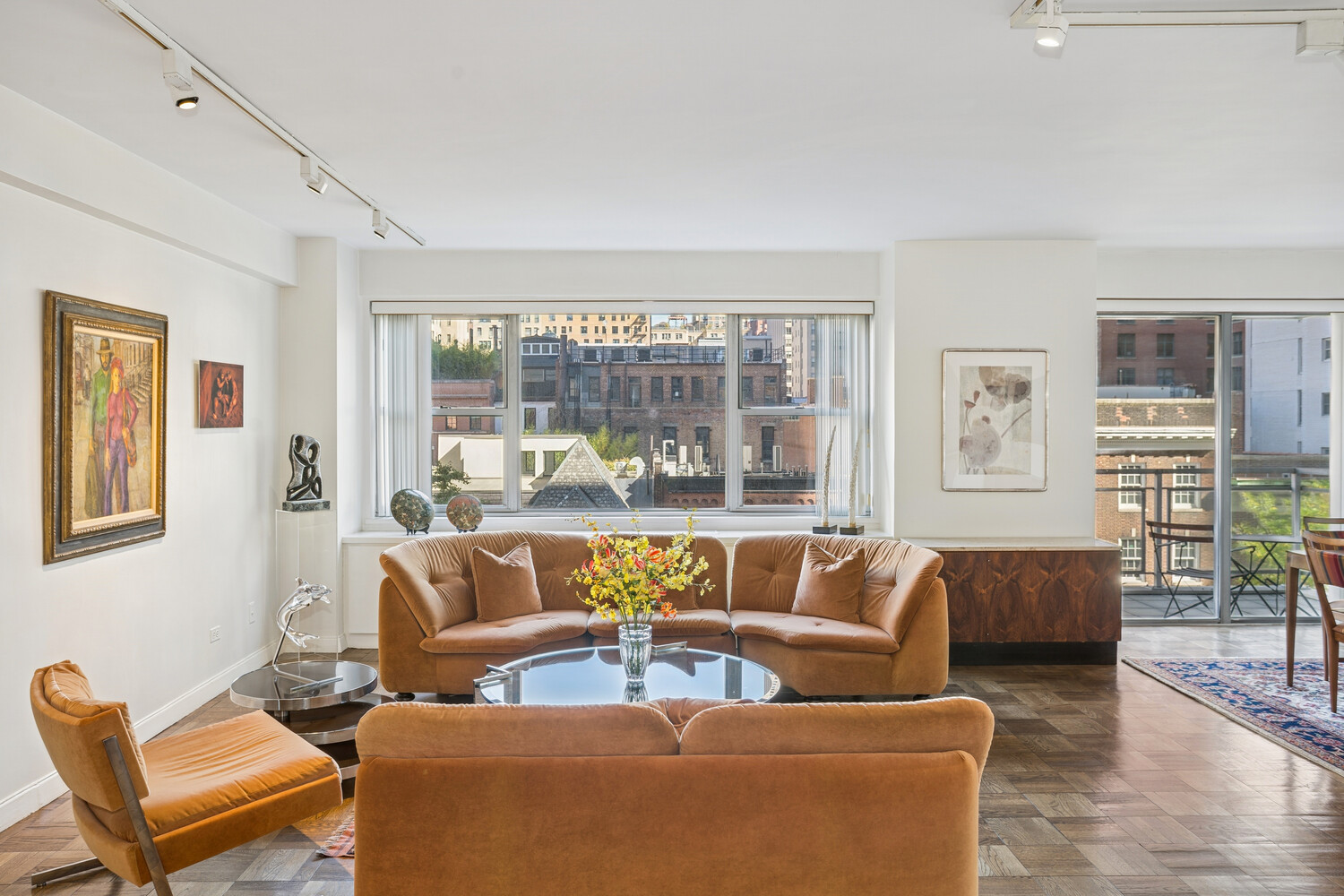 150 East 69th Street, Unit 5J Manhattan, NY 10021 - Photo 2 of 11 a living room with furniture and a large window