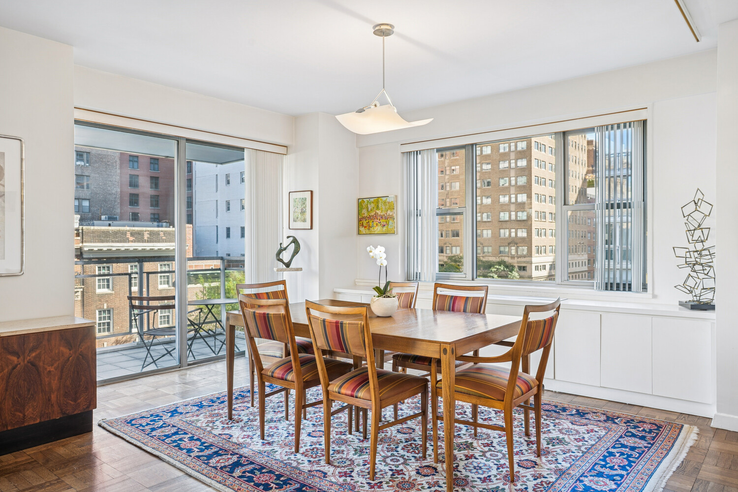 150 East 69th Street, Unit 5J Manhattan, NY 10021 - Photo 4 of 11 a view of a dining room with furniture window and wooden floor