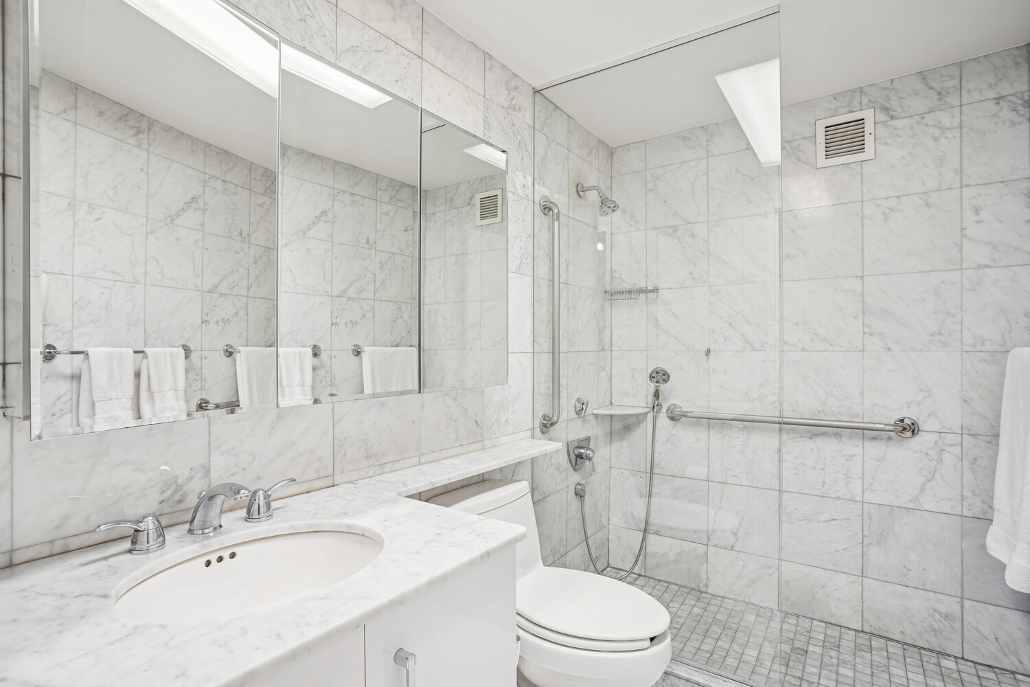 150 East 69th Street, Unit 5J Manhattan, NY 10021 - Photo 8 of 11 a bathroom with a sink a toilet and shower
