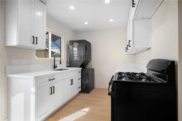 a kitchen with stainless steel appliances a sink stove and refrigerator